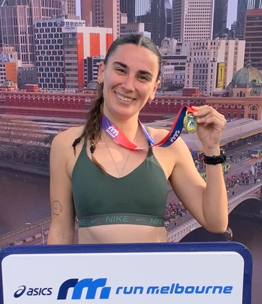 Georgia at Run Melbourne in July 2026, holding her medal